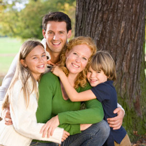family hugging by tree sq - Alive and Free Chiropractic