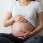 Pregnant woman receiving chiropractic care during pregnancy safe treatment for back pain relief