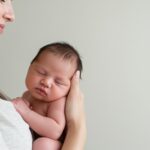 Natural colic remedies help Cooper City baby sleep peacefully in mother's arms after chiropractic care