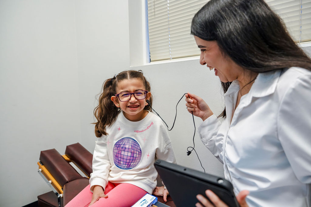 A child completing a nervous system scan with the AFC team